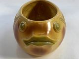 a brown vase with a fish face on it