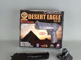 a gun that is sitting on a table next to a box