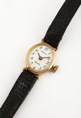 a close up of a wrist watch on a white surface