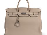 a beige leather handbag on a white background