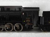 a black toy train on a white surface