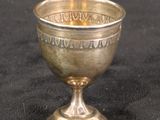 a silver cup on a black table cloth