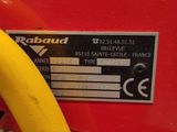 a close up of a yellow banana on a red machine