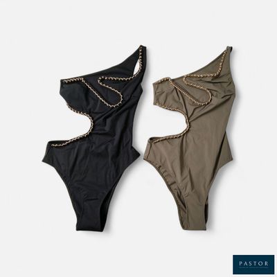 two women ' s swimsuits with chains hanging from them