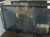two computer monitors sitting on top of a table next to each other