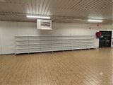 a large empty room with a lot of shelves in it