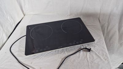 a black stove top with two burners on it