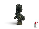 a bronze bust of a woman on a white background