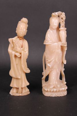 three carved ivory figurines of a woman and a man