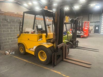 a yellow forklift truck parked in a warehouse