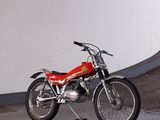 a red motorcycle parked in a parking garage
