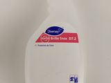 a close up of a bottle of hand sanitizer on a white surface