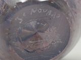 a close up of a purple vase with writing on it