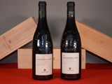 two bottles of wine sitting next to each other on a table