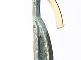 sculpture of a curved metal object on a white surface
