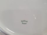 a white plate with a red and green design on it