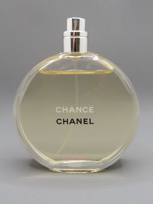 a close up of a bottle of perfume on a gray surface