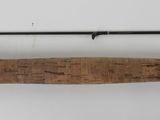 a close up of a fishing rod on a white surface