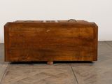 an old wooden suitcase sitting on a parquet floor