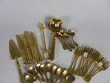 a lot of silverware on a white table