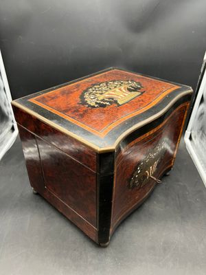 a small wooden box with a lion design on it