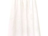 a white skirt with a flower pattern on the bottom of it