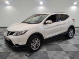 a white nissan suv is parked in a room with a checkered floor