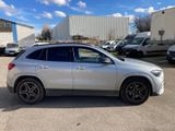 a silver mercedes suv parked in a parking lot
