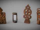 several pieces of carved wood sitting on top of a white surface