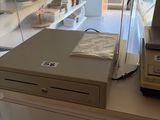 a cash register sitting on top of a table in a store