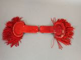 a red belt with red fringes on it on a table