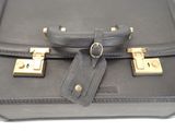 a black suitcase with a tag attached to it