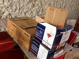 boxes of beer are stacked on top of a table in front of a wall