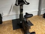 a close up of a stationary exercise bike in a garage