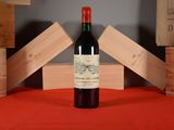 a bottle of wine sitting on a red table cloth