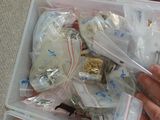 a person holding a plastic container filled with assorted items