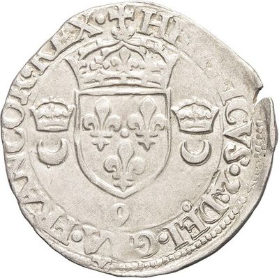 a close up of a silver coin with a crown on top of it