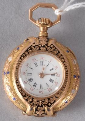 a gold pocket watch with roman numerals on it