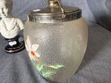 a glass vase with a statue of a boy and a fish in it