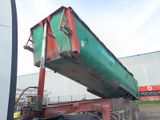 a green and red truck with a red trailer attached to it