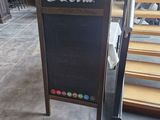 a chalk board with a coca cola sign on it