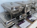 several trays of food sitting on top of a white table