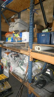 a shelf full of tools and other items in a garage
