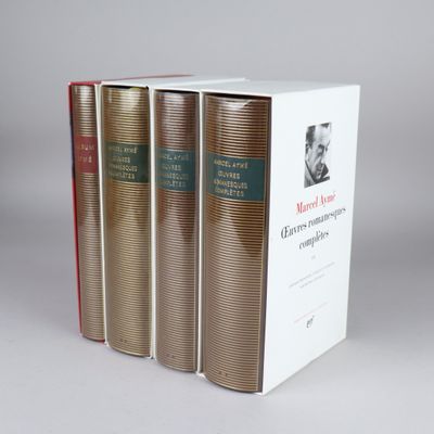 three books are stacked on top of each other on a white surface