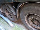 a truck tire with a hose attached to the side of it