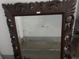 a mirror that is sitting on the floor next to a chair