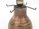 a brown vase with a black top on a white background