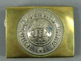 an image of a gold belt buckle with a coat of arms on it