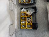 two bins of screws and other tools on the floor