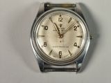 a silver wrist watch with a white face on a table